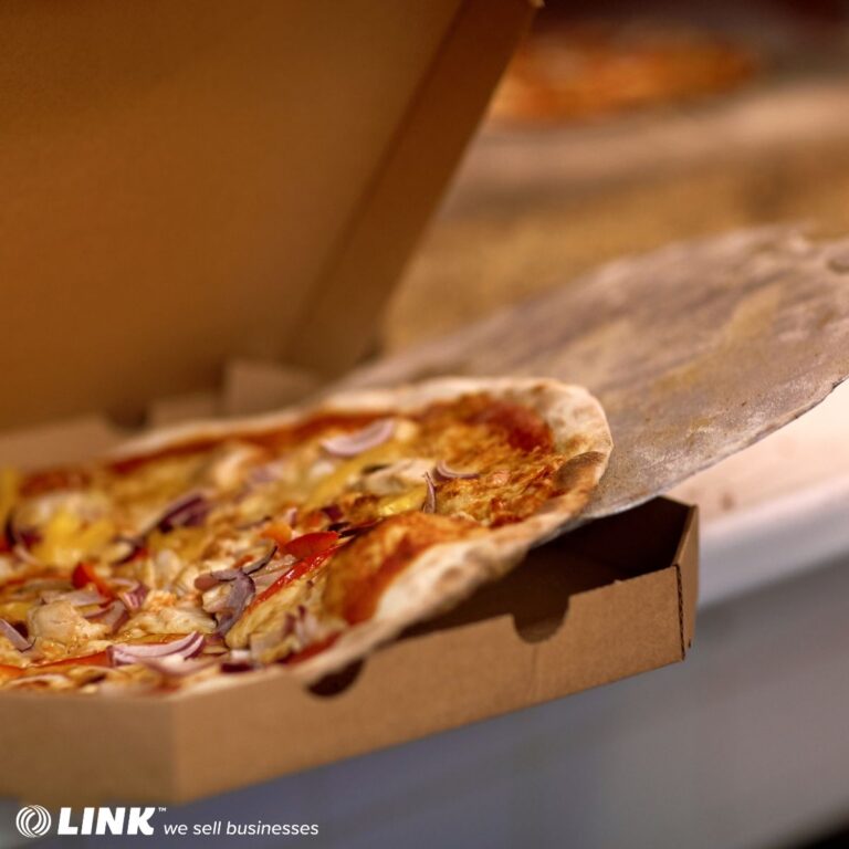 Fresh pizza in delivery box - successful franchise exit strategy with business broker